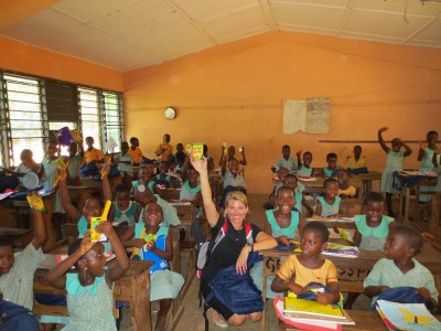 A woman in a classroom with students in Ghana